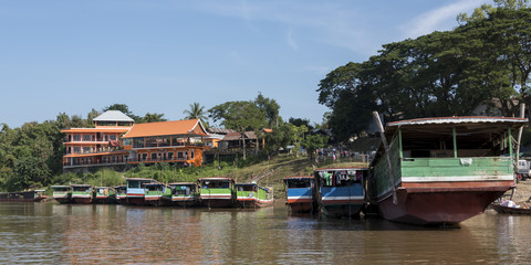 Houseboats along shoreline of River Mekong, Laos