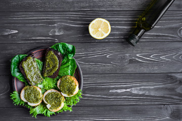 pesto and bread on a wooden background