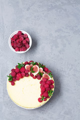 Cheesecake with raspberries and figs on a gray background, raspberry, berries, cake, vertical, soft focus, sweets