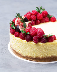 Cheesecake with raspberries and figs on a gray background, raspberry, berries, cake, vertical, selective focus, sweets