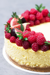 Cheesecake with raspberries and figs on a gray background, raspberry, berries, cake, vertical, selective focus, sweets
