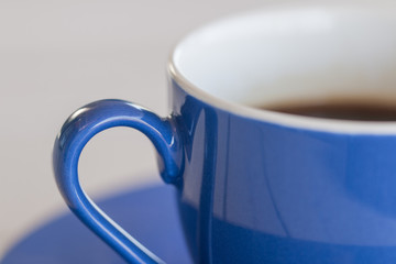 A blue cup of coffee, detail.