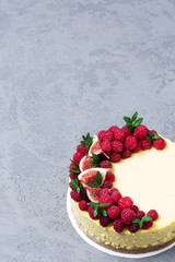 Cheesecake with raspberries and figs on a gray background, raspberry, berries, cake, vertical, selective focus, sweets