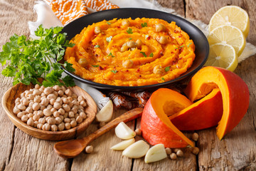 Vegetarian food: hummus with pumpkin and ingredients close-up. horizontal
