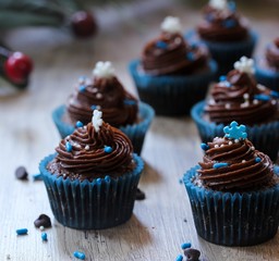 Mini Frosted Chocolate cupcakes on Christmas Holiday background