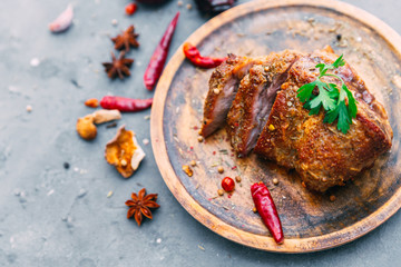 Grilled meat with spices. Vintage background. Flat lay