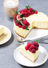 Cheesecake with raspberries and figs on a gray background, raspberry, berries, cake, vertical, selective focus, sweets
