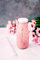 smoothie in milk bottle with flowers