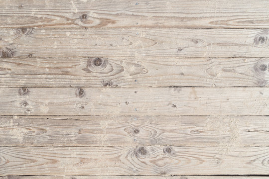 Wooden beach boardwalk with sand, viewed from above, background.