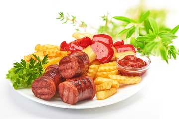 grilled sausages with potatoes fries and sweet bulgarian peppers and red sauce ketchup