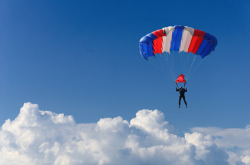 skydiver soars in the sky high above the clouds