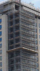 Extensive scaffolding providing access for work in progress on a tower block in UK