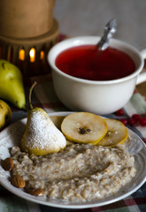 Porridge with pear and tea with berries for breakfast