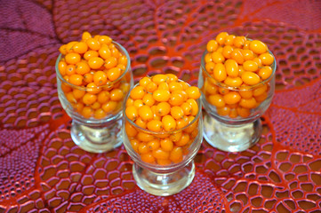 3 glasses filled with ripe sea-buckthorn berries