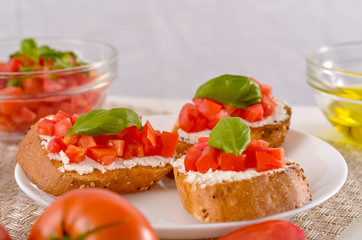 delicious bruschetta with tomatoes on plate on table close-up