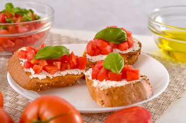 delicious bruschetta with tomatoes on plate on table close-up
