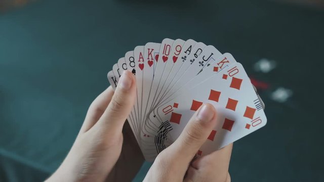Bridge card game,female hand  shuffling cards close up