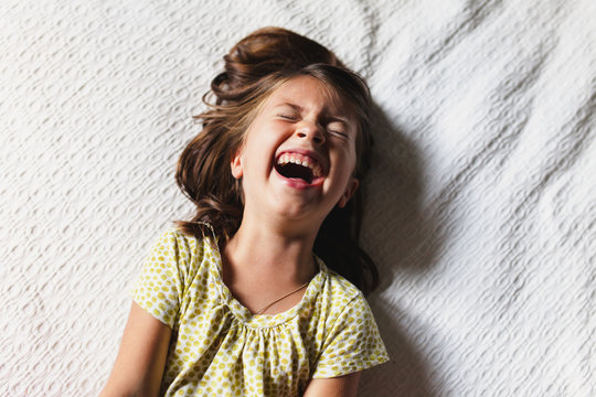 Young girl laying down laughing