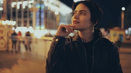 Slowmotion of young pretty woman in city street enjoying a nighttime life
