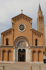 Fototapeta na wymiar Bell Tower and facade of Church in Jesolo City Italy