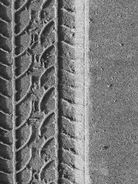 Close up of tire tracks on beach