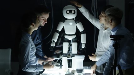  Portrait smiling electronics engineers collaborating on design of robot