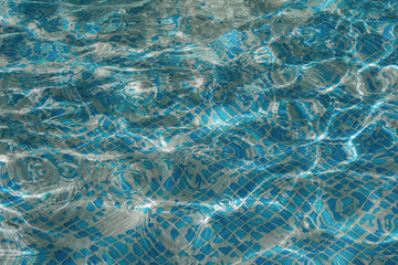 Water in swimming pool with reflection and caustic network