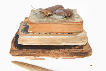 Old eyeglasses and paper case on vintage books