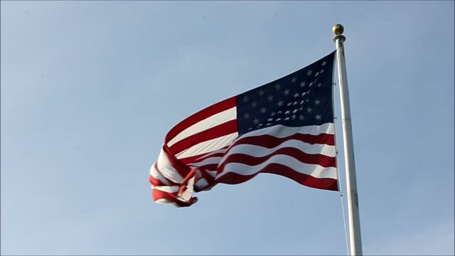 Slow motion American flag twisting and waving