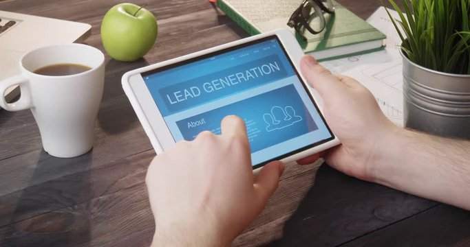 Reviewing lead generation internet page using digital tablet at desk