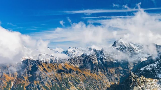 Snowy Tatra mountains peaks in clouds, Poland and Slovakia landscape, time lapse
