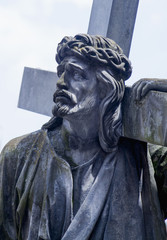 Jesus Christ Carrying the crossThe road to Golgotha. Ancient statue of Jesus Christ carrying the Holy Cross. (holy, faith, religion, god, suffering concept)