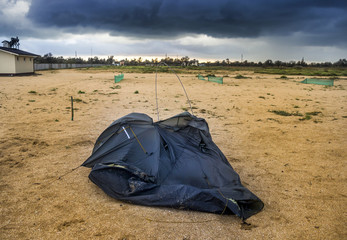 broken tent at the beach