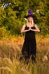 Nice female in Halloween costume practicing yoga