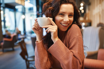 woman drinking coffee in a cafe - 175535610