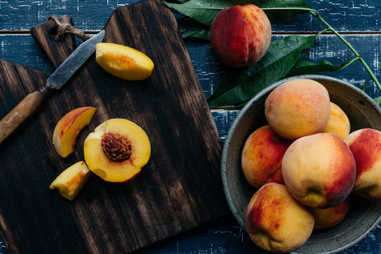 Fresh peaches on a chopping board from above - Powered by Adobe