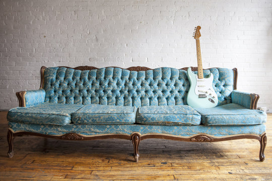 Fototapeta vintage blue couch with vintage blue guitar