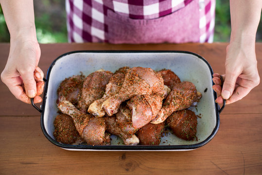 Woman preparing fried chicken drumsticks