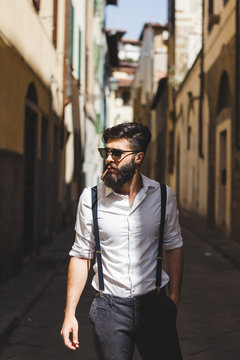 Fashionable young bearded man in old town alley