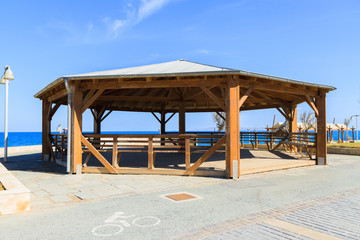 Wooden gazebo pergola playground recreation area at seaside public park