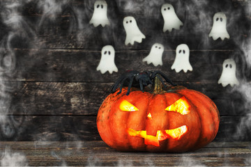 Spooky Halloween pumpkin head jack lantern on wooden background 