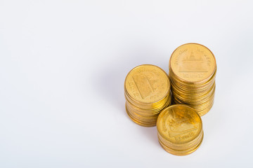 Columns of gold coins, piles of coins on white background