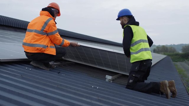  Technicians checking the panels at solar energy installation