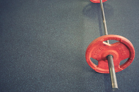 Vivid Barbell On Floor In Gym