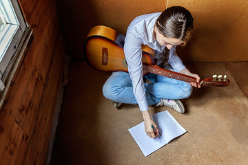 girl with a guitar who writes a song