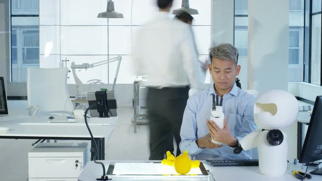  Time lapse electronics engineers working on a prototype for automated robot