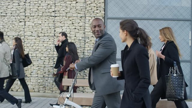  Diverse professional group walking to work in the morning