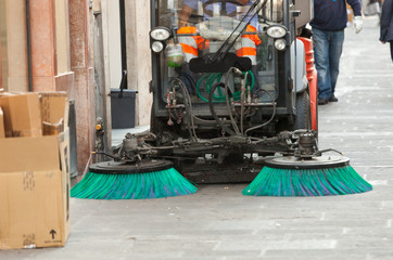 Fototapeta na wymiar Street sweeper machine cleaning the streets