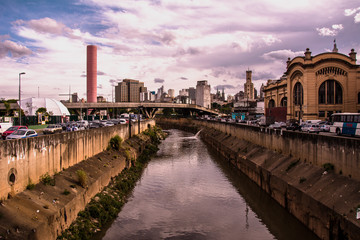 River and large streets in a South american big city during the end of the afternoon