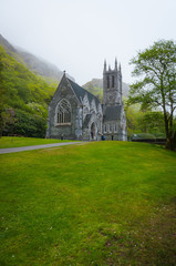 Fototapeta na wymiar Chapel on hill in mist at Kylemore Abbey, Galway